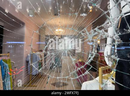 Broken window glass in a clothing store. Stock Photo