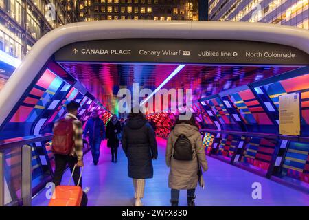 Captivated By Colour artwork by Camille Walala in Adams Plaza Bridge, Canary Wharf, London, England, UK, with people walking through the tunnel Stock Photo