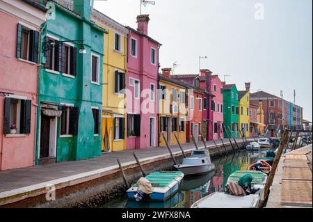 Burano, Italy- Feb 25, 2023; Colorful houses along a canal in Burano Italy Stock Photo