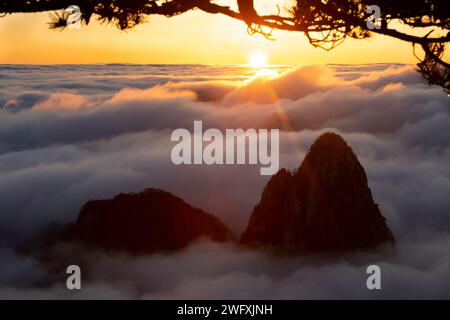 Sea of Clouds surrounding Lion Peak as seen from Stone Monkey in North Sea area of Huangshan's Yellow Mountains. Stock Photo