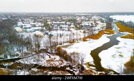 Aerial view of a snow-covered rural landscape with frost-covered trees ...