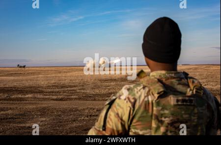 U.S. Army Sgt. Christopher Drummond, Fire Control Specialist from Headquarters and Headquarters Battalion, 82nd Airborne Division, “Task Force 82,” oversees the firing of an M142 High Mobility Artillery Rocket System (HIMARS) at Smardan Training Area, located in Galati County, Western Moldavia, Romania, Jan. 17, 2024. The Reduced Range Practice Rockets were fired by the Romanian 8th Field Artillery Brigade, and supported by U.S. Army 4th Battalion, 4th Security Forces Assistance Brigade, attached to “Task Force 82.” The artillery exercise afforded the artillery crew members the opportunity to Stock Photo