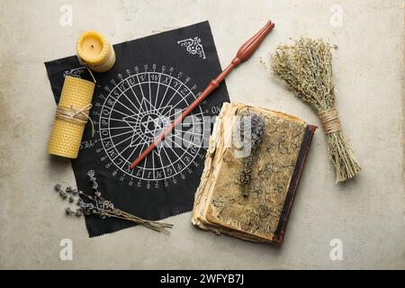 Flat lay composition with magic wand and divination cloth on light textured background Stock Photo