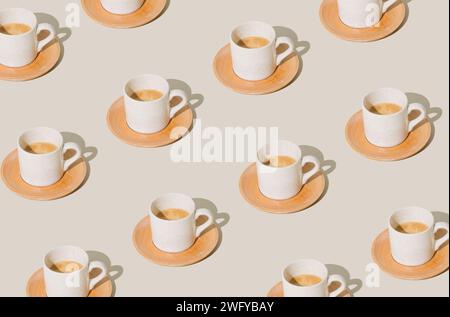 Trendy pattern made of cup of coffee on light pastel background. Creative coffee concept. Minimal espresso pattern idea. Coffee aesthetic. Stock Photo