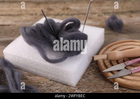 Felting tools and wool on wooden table, closeup Stock Photo