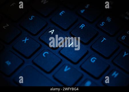 keyboard being illuminated with blue light highlighting letters a i Stock Photo