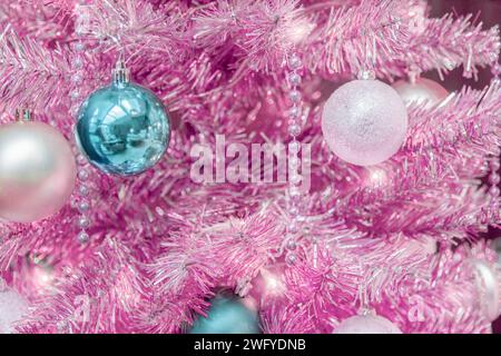 Pink and silver tinsel Christmas tree with ornaments Stock Photo