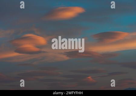 Lenticular clouds shown at dusk during a windy in Southern California Stock Photo