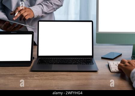 man hands and laptop with blank screen mock up Using laptop computer modern sitting at office Stock Photo