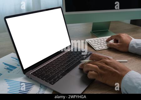 man hands and laptop with blank screen mock up Using laptop computer modern sitting at office Stock Photo