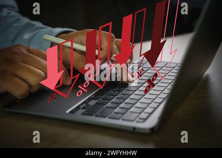 Another recession, another failure. Laptop displaying a business graph, person working on data analysis, technology and finance recession concept Stock Photo