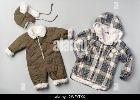 Warm baby coat for boys on gray background top view Stock Photo