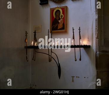 Cambridge, United Kingdom - June 26, 2010: Candle holder with burning candles under the Icon of the Virgin Mary and the Christ Child in Great Saint Ma Stock Photo