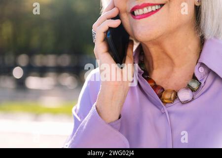 senior woman smiling happy talking by mobile phone Stock Photo