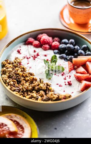 A bowl full of berries, yogurt and cereal. Healthy breakfast concept. Stock Photo
