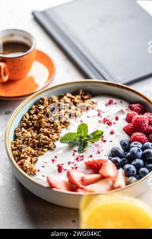A bowl full of berries, yogurt and cereal. Healthy breakfast concept. Stock Photo