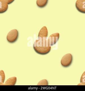 Easter cookies shaped of bunny and eggs on yellow background. Easter seamless pattern. Stock Photo