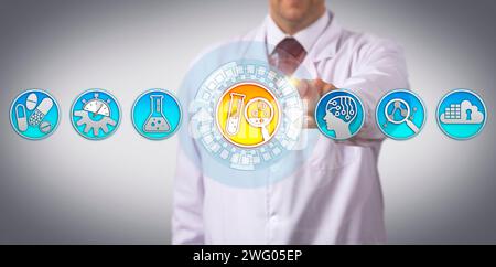 Unrecognizable industrial scientist is initiating the drug discovery process via touch screen interface. Pharmaceutical industry concept for research Stock Photo