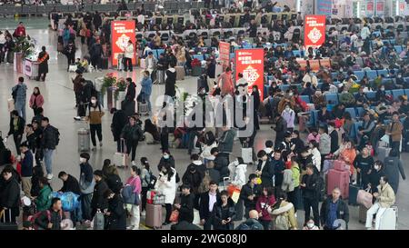 Passengers wait for their trains at Guangzhounan railway station in ...