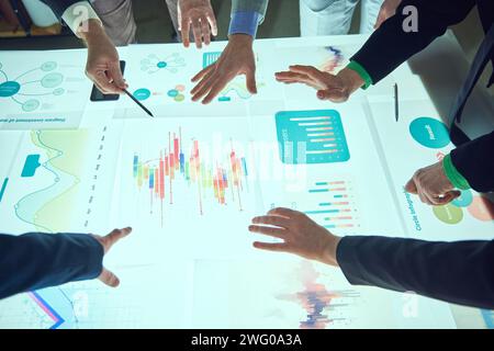Colleagues, project managers working with analytical papers, looking on charts, metrics and KPI, analyzing profitable and promotional strategies for Stock Photo