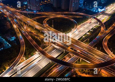 A bird's-eye view of the night view of Wuhan Guanggu Avenue overpass, with the wide urban main road illuminated by warm colored lights Stock Photo