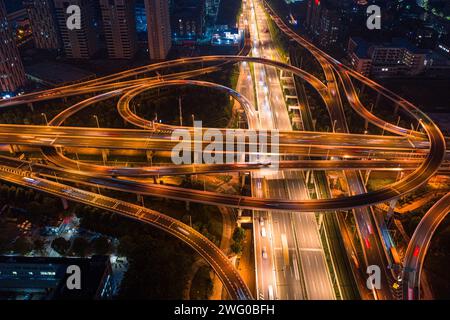 A bird's-eye view of the night view of Wuhan Guanggu Avenue overpass, with the wide urban main road illuminated by warm colored lights Stock Photo