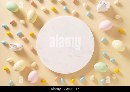 Easter frame with sweet chocolate eggs, painted pastel pink eggs on yellow background. Homemade cook for holiday. View from above. Copy space, Festive Stock Photo