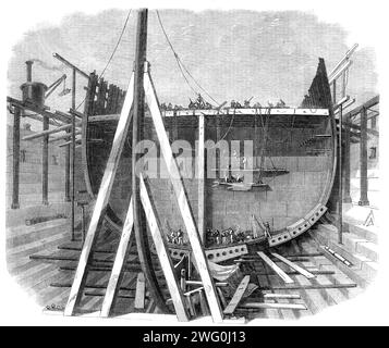 The new iron-clad fleet: framing of Her Majesty's steam-frigate Achilles, 50 guns, 1862. 'The construction of this gigantic iron frigate, under the superintendence of Mr. 0. W. Lang, the master shipwright of Chatham Dockyard, is proceeding with the greatest rapidity towards completion: the vessel is nearly in frame, and the progress day by day is something wonderful...the forward state of everything in connection with the new fleet at this establishment reflects the highest credit on all the officials connected with it. The stem of the Achilles...is a splendid specimen of iron-forging; it was Stock Photo