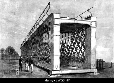 Span of a large iron lattice-bridge to cross the River Jumna, near Delhi, 1862. 'Messrs. Ormerod, Grierson, and Co., of the St. George's Ironworks, Hulme, in Manchester, have just completed the first of a series of twelve spans...The bridge is for the East India Railway Company, and is from designs by A. M. Rendel. It is so constructed as to answer the double purpose of a railway and an ordinary road, the railway being along the top and the roadway beneath it...It is an unusual feature in this structure that none of the rivet holes are punched. Multiple drilling-machines, five in number, were Stock Photo
