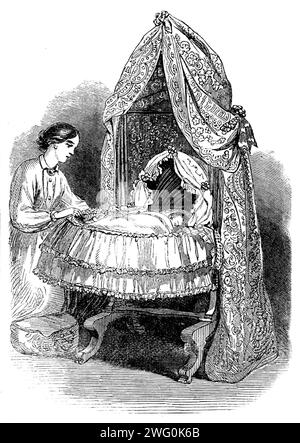 The International Exhibition: new swing-cradle by Norman, 1862. 'This little arrangement, which is of the deepest interest to our fair readers, may be said to be a cradlelike cot which swings from head to foot, and not from side to side in the usual manner, the peculiarity consisting in the direction of the motion rather than in its form. There can be little doubt that the alteration in the direction of the motion here made is desirable; and to those who still retain the idea that it is advisable that a child be rocked we would certainly recommend this cot, especially if the pillow be kept hig Stock Photo