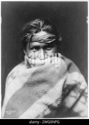 A son of the desert, c1904. Navajo man, head-and-shoulders portrait, facing front, wrapped in a blanket that covers his mouth. Stock Photo