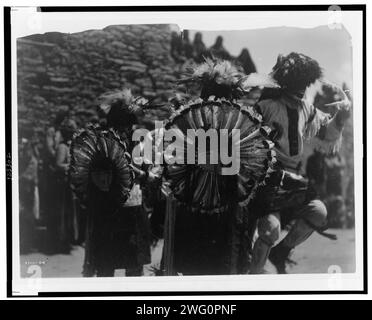 Buffalo dancers, c1905. Costumed dancers wearing dance bustles of Tewa sun god made of turkey feathers. Stock Photo