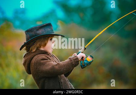 Kid fishing with spinning reel. Kids fly fishing Stock Photo