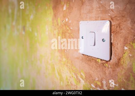 White light switch closeup during room renovation in england uk. Stock Photo
