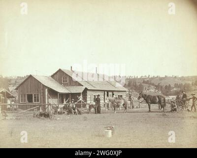 Western Ranch House, c1888. Farm equipment, horses, wagons, dogs and people posed in front of western ranch houses. Stock Photo