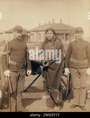 Tasunka, Ota (alias Plenty Horse[s]), the slayer of Lieut Casey, near Pine Ridge, SD, 1891. Plenty Horses, Oglala man, full-length portrait, facing front, with a blanket wrapped around him, standing next to a cannon, probably on or near Pine Ridge Reservation. Stock Photo