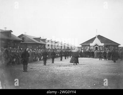 Prayer in a Prison Courtyard, 1890 This photograph is from a collection consisting of an album and individual photographs preserved in the Aleksandrovsk Municipal History and Literature Museum &quot;A.P. Chekhov and Sakhalin&quot; in Alekandrovsk-Sakhalinskiy, Sakhalin Island (off Russia's southeast coast). The photographs were taken on Sakhalin Island during the late 19th and early 20th centuries and provide rare glimpses of the island's settlements, prisons, and inhabitants. Sakhalin Island was used by imperial Russia as a penal colony and place of exile for criminals and political prisoners Stock Photo