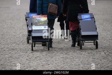 Dresden, Germany. 02nd Feb, 2024. People with mobile information stands, with information from Jehovah's Witnesses, walk across the Postplatz. Credit: Robert Michael/dpa/Alamy Live News Stock Photo