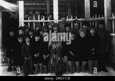 Pupils of the parish school, 1890. The album &quot;Views of the Yakutsk Region&quot; contains 151 photographs. Subjects include the Lena River shore; various forms of river transport--including boats, rafts, trade barges, and steamships; post offices along the Lena highway, and transport by horse and reindeer. Several of the photographs are signed with the initials &quot;I. P.&quot; Irkutsk State University Stock Photo