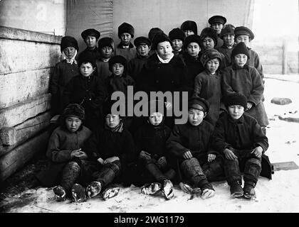 Schoolchildren, 1890. The album &quot;Views of the Yakutsk Region&quot; contains 151 photographs. Subjects include the Lena River shore; various forms of river transport--including boats, rafts, trade barges, and steamships; post offices along the Lena highway, and transport by horse and reindeer. Several of the photographs are signed with the initials &quot;I. P.&quot; Irkutsk State University Stock Photo