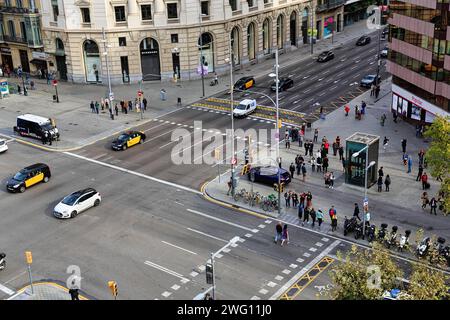 Crossroads with cars, taxis, pedestrians, view from above, Passeig de Gracia, Barcelona, Spain Stock Photo