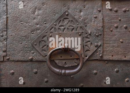 Door knocker on a rusty entrance door in the historic city centre, Genoa, Italy Stock Photo