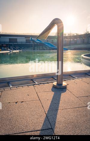 Outdoor pool with an outdoor shower in the shining sunlight, ENCW outdoor pool Calw, Stammheim, Black Forest, Germany Stock Photo