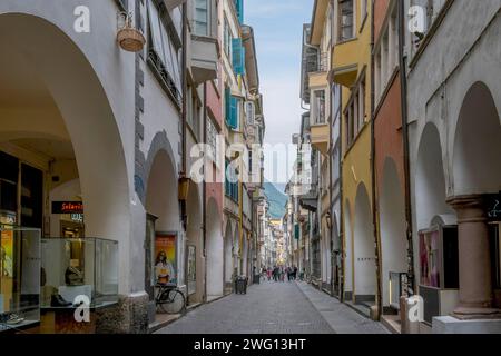 View through a lively pedestrian zone with arcades and shops, historic arcade in the old town centre of Bolzano, South Tyrol, Italy Stock Photo
