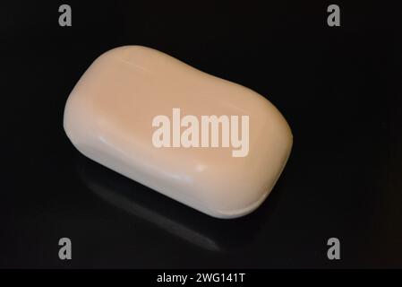 Clothes, personal hygiene products, new white hand soap placed on black background. Stock Photo