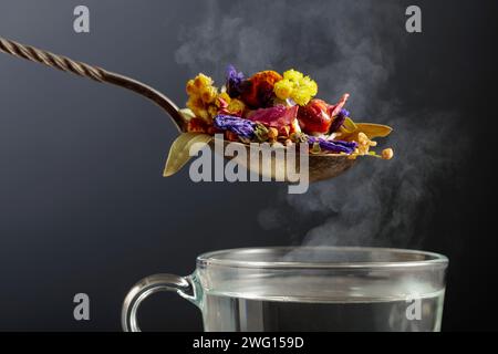 Mix of various dried medicinal plants and herbs for herbal tea on a black background. Stock Photo