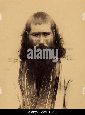 An Ainu Tribal Elder from the Settlement of Taraiki in Southern Sakhalin, 1880-1899. From an album created on Sakhalin Island in the 1890s. Sakhalin was used by imperial Russia as a penal colony and place of exile for criminals and political prisoners. Between 1869 and 1906, more than 30,000 inmates and exiles endured the harsh conditions of the forced-labor colony on the island. The album contains photographs that provide rare glimpses of Sakhalin's settlements and prisons and the prisoners, exiles, and guards who inhabited the island.  Anton Chekhov, the Russian writer and medical doctor, sp Stock Photo