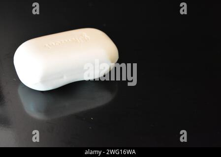 Clothes, personal hygiene products, new white hand soap placed on black background. Stock Photo