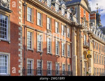 A winter sun falls on the facade of an elaborate Edwardian red-brick building. Originally the offices of a railway company, but now a hotel. Stock Photo