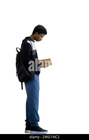 A man, full-length, on a white background, with a backpack, writes Stock Photo